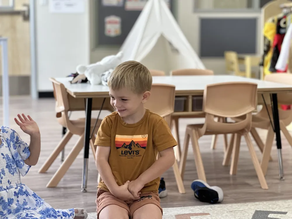 A child smiling during a classroom activity