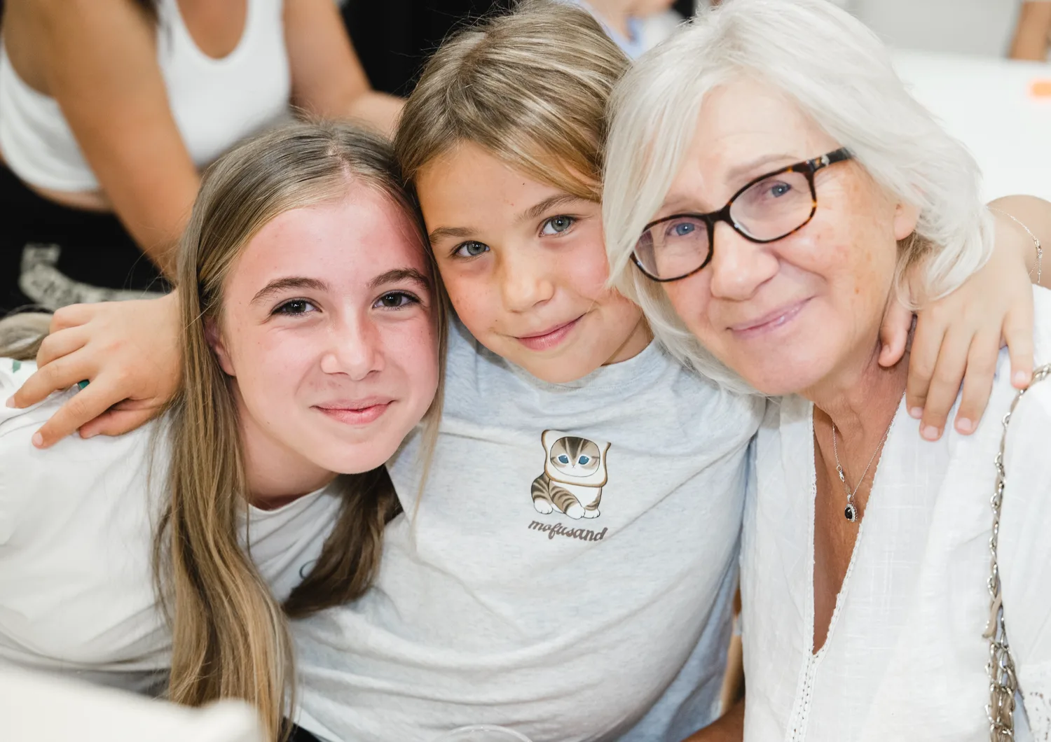 Two children and a caring adult smiling together
