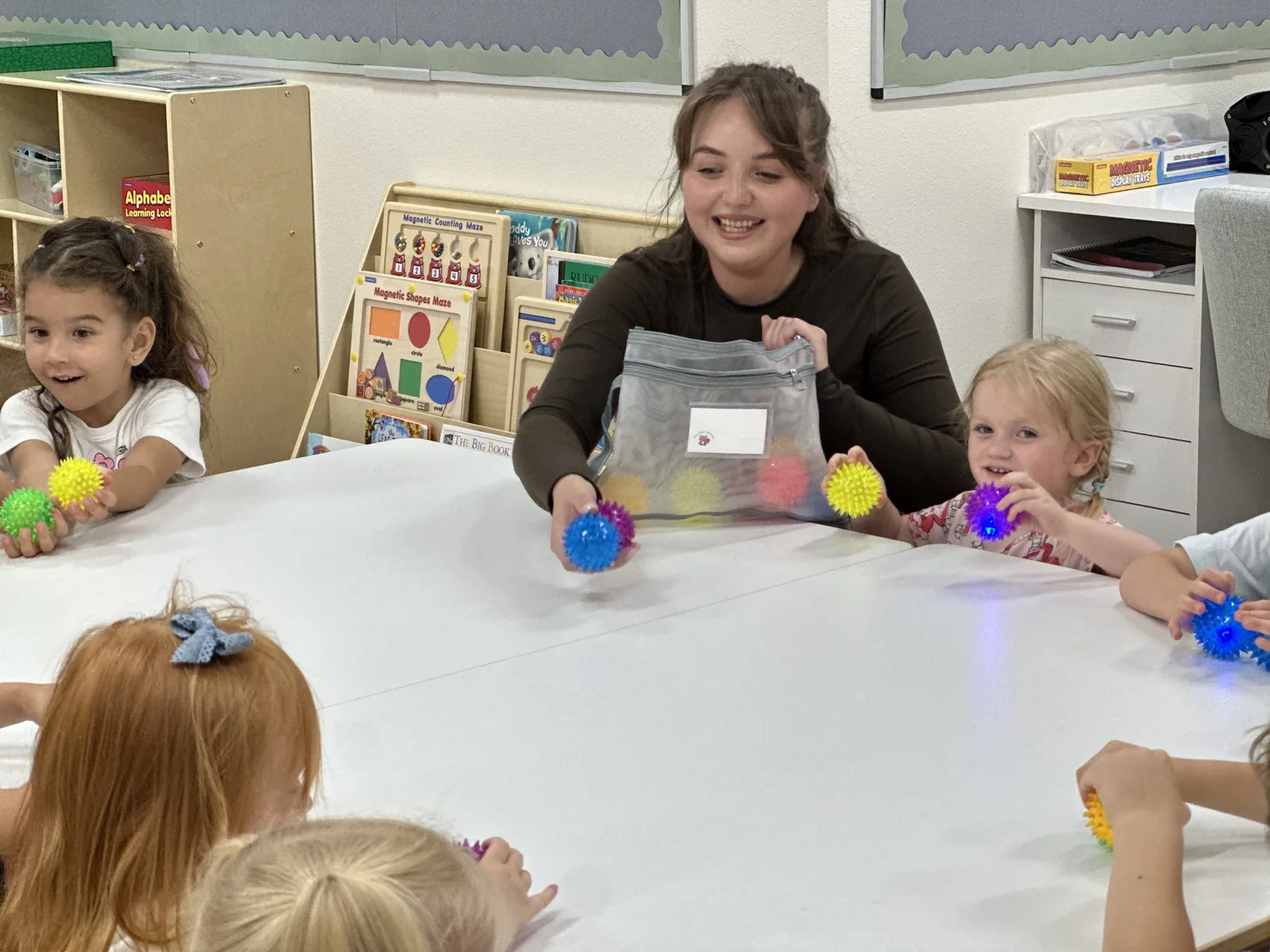 An educator leading a group of children in a classroom activity